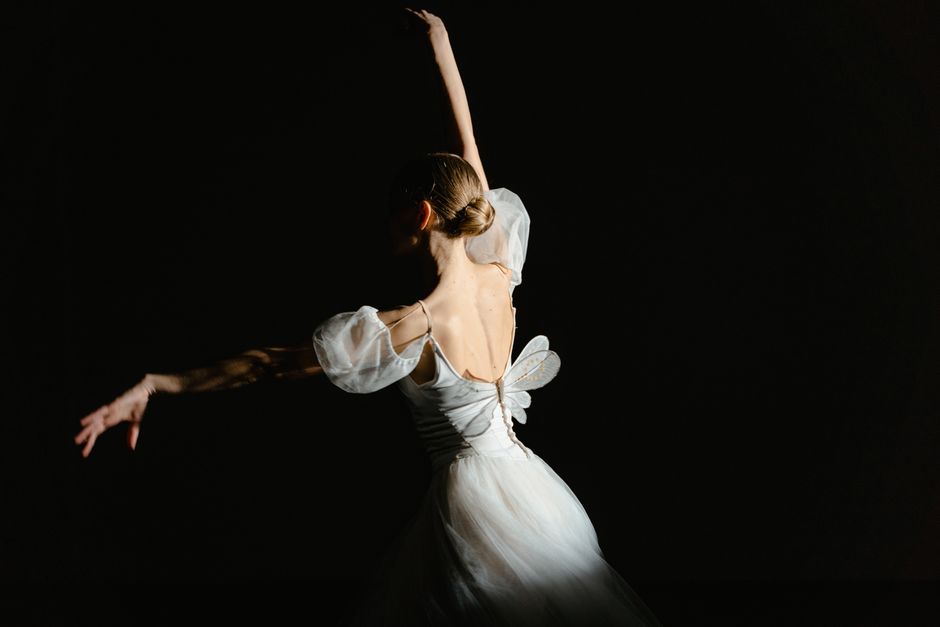 Bailarines en una representación de danza clásica sobre un escenario iluminado